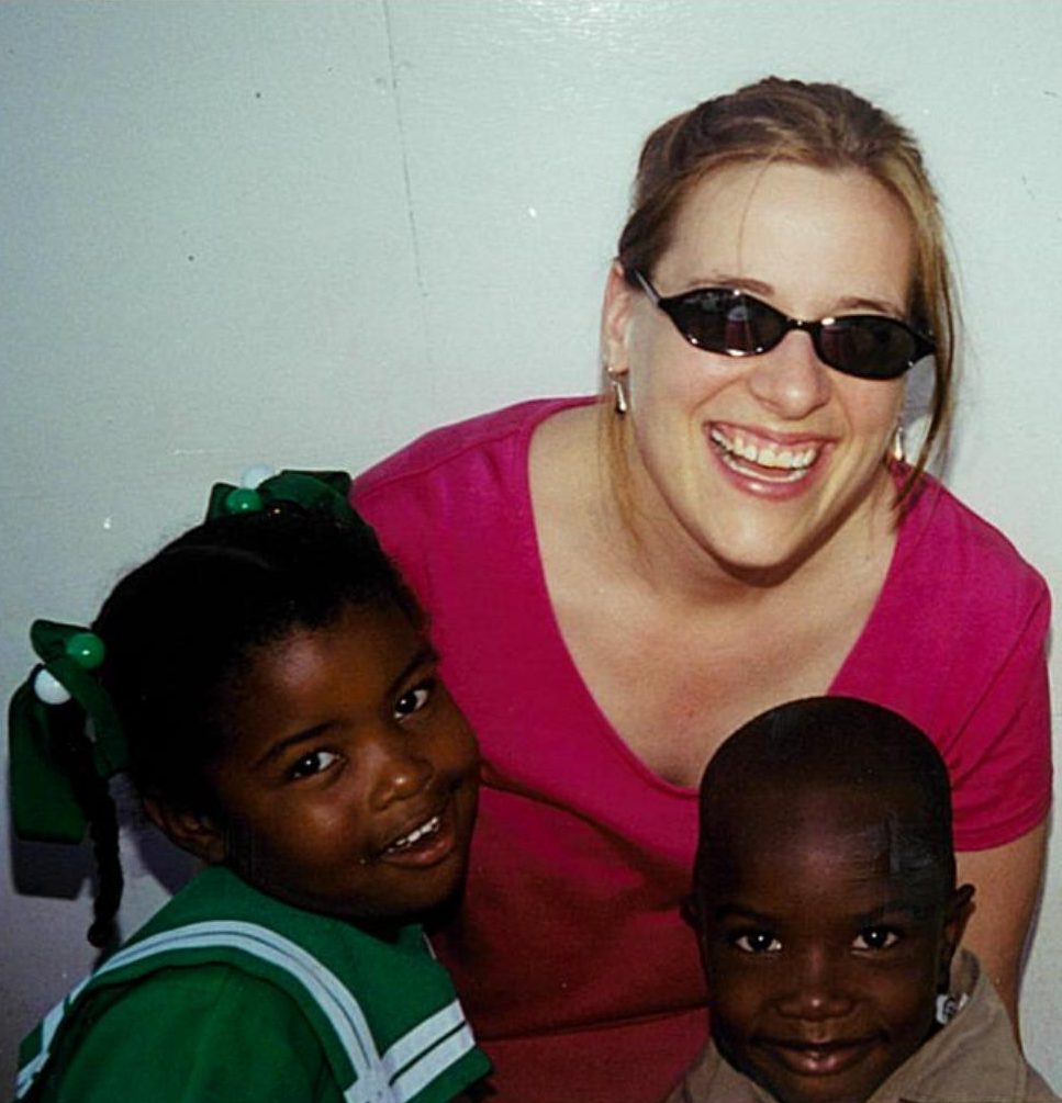 women hugging two boys